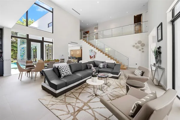 a living room with furniture and a chandelier