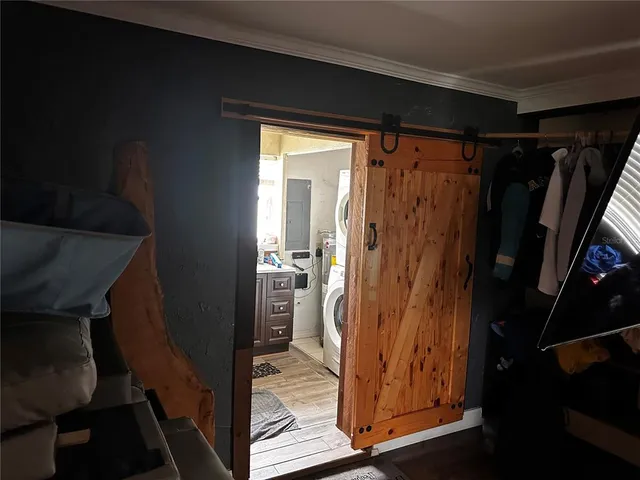 a bed sitting in a bedroom next to a window