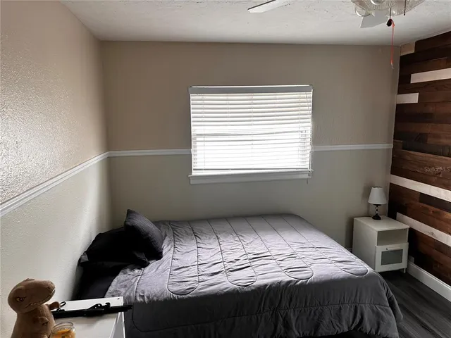 a view of bedroom with furniture and flat screen tv