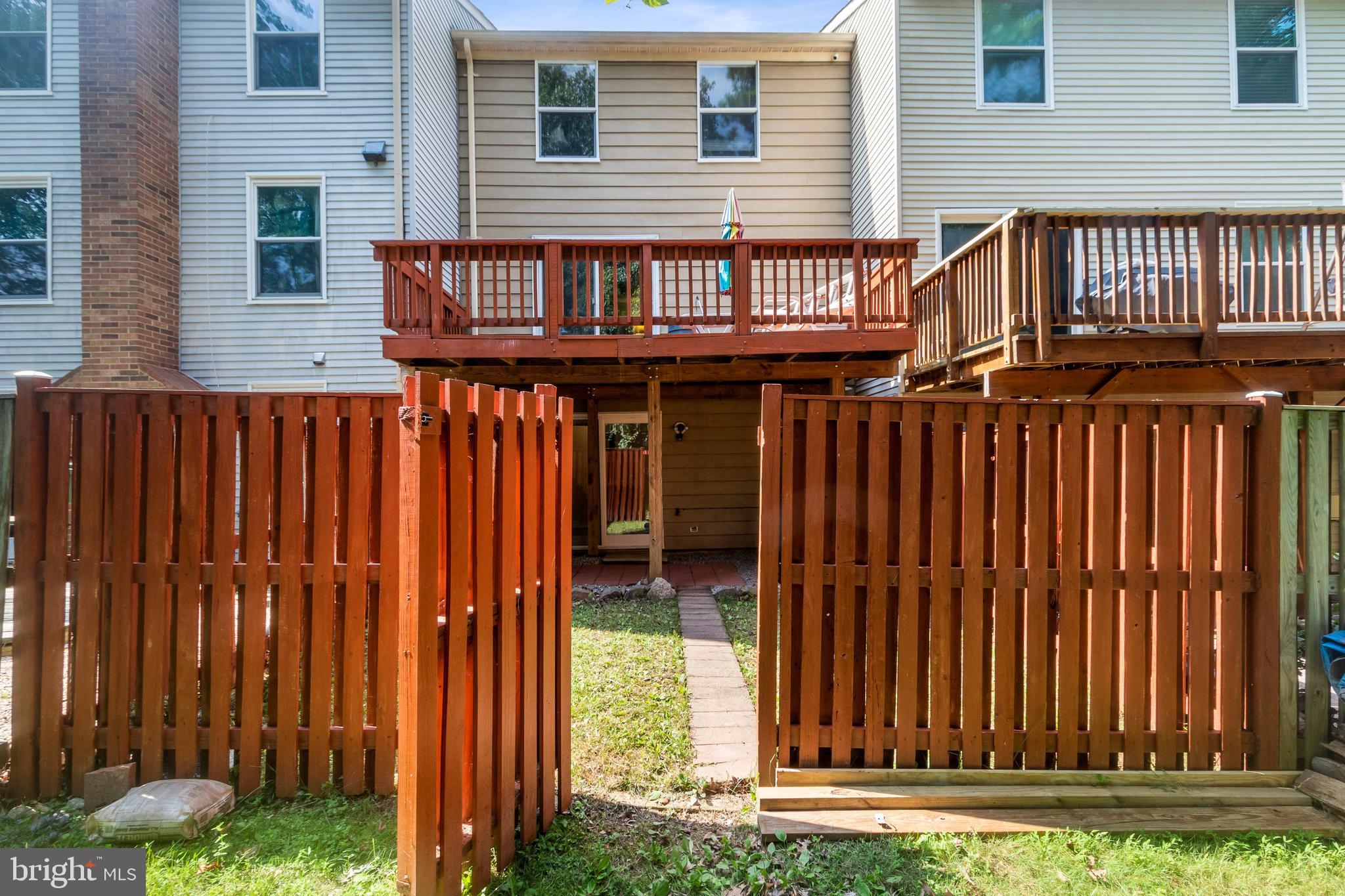 15057 Mill Spring Drive Dumfries, VA 22025 - Photo 20 of 20 a view of a house with a wooden fence