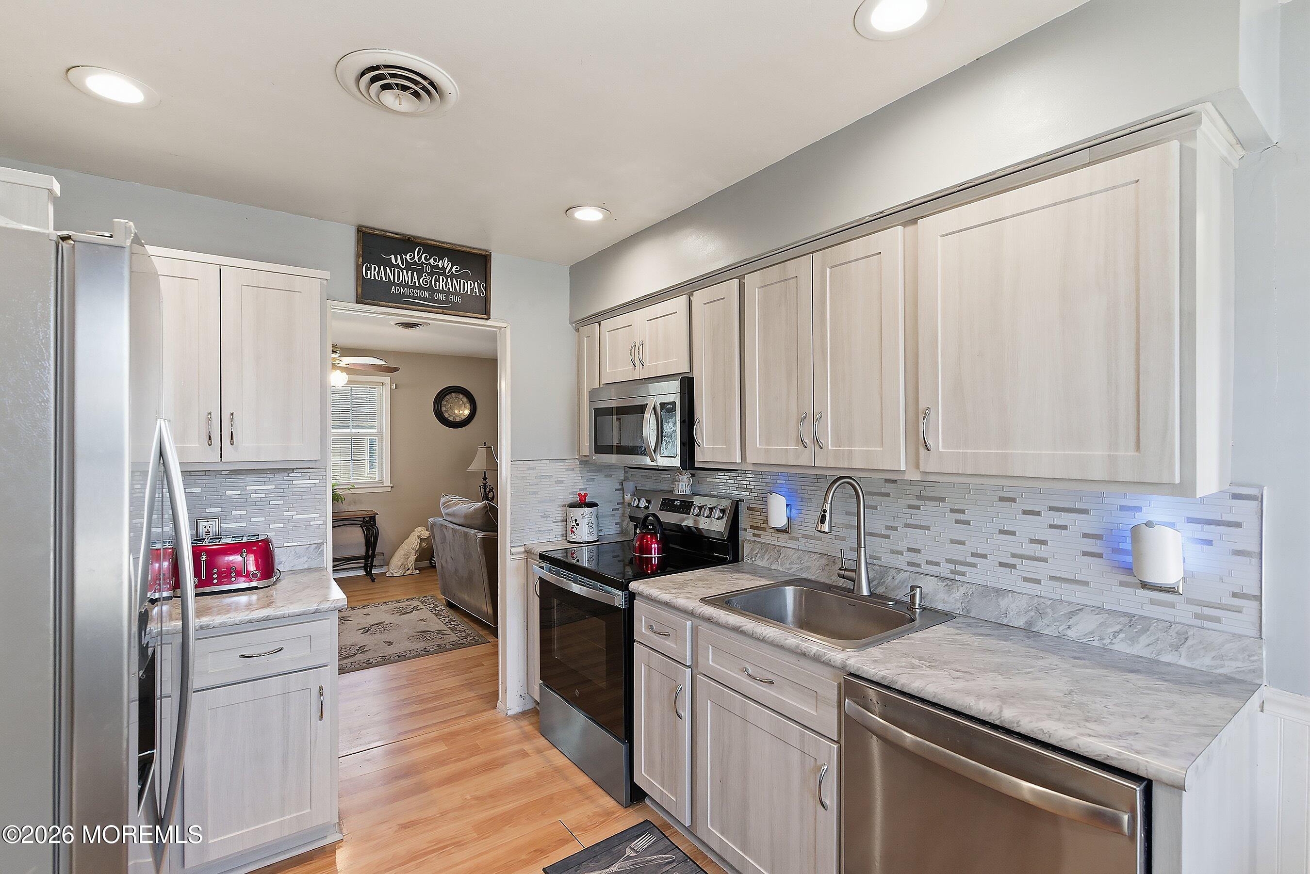 56 South Chestnut Avenue Whiting, NJ 08759 - Photo 16 of 44 a kitchen that has a sink and a stove in it