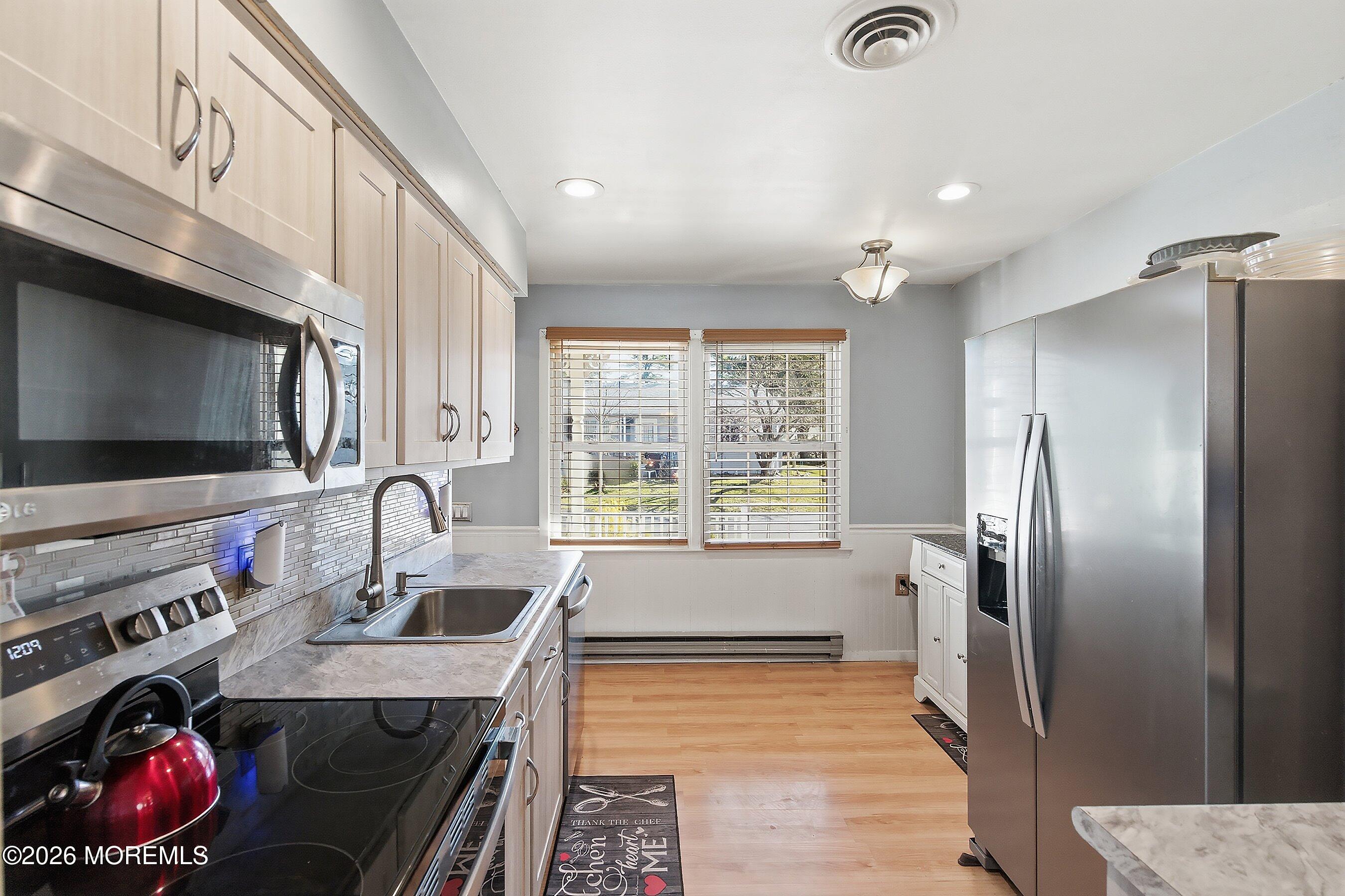 56 South Chestnut Avenue Whiting, NJ 08759 - Photo 17 of 44 a kitchen with stainless steel appliances granite countertop a sink stove and refrigerator