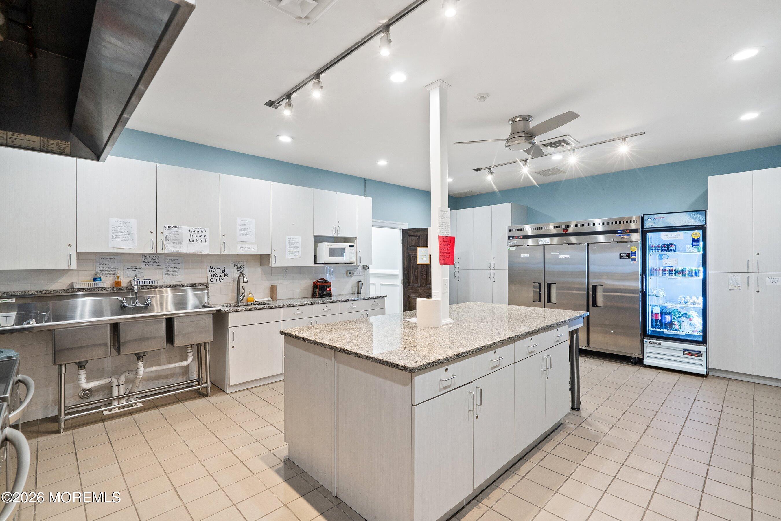 56 South Chestnut Avenue Whiting, NJ 08759 - Photo 41 of 44 a kitchen with stainless steel appliances granite countertop a sink dishwasher a stove and a refrigerator with cabinets