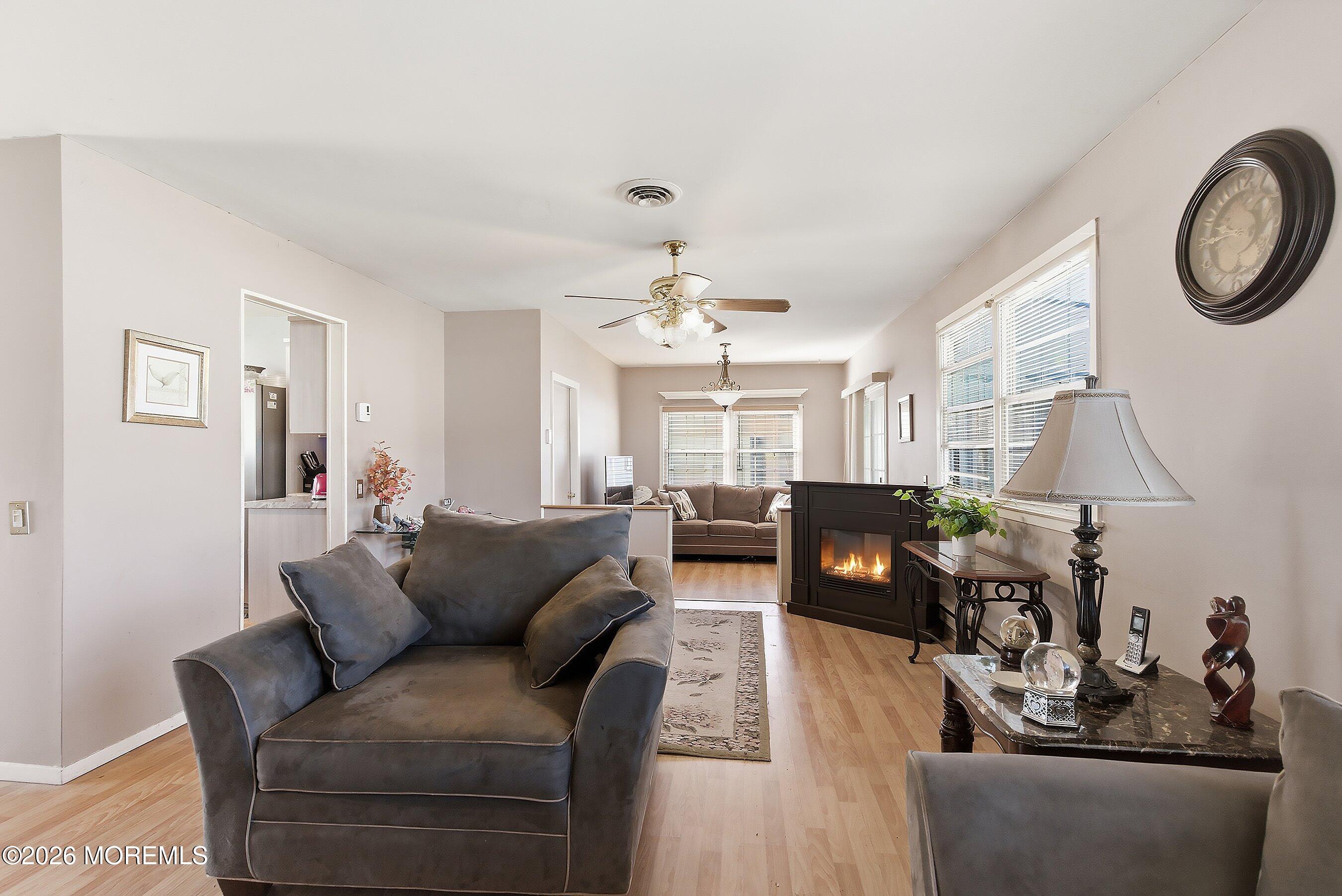 56 South Chestnut Avenue Whiting, NJ 08759 - Photo 10 of 44 a living room with furniture a clock and a chandelier
