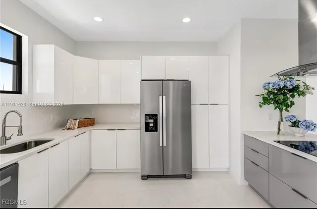 a kitchen with a refrigerator and a sink