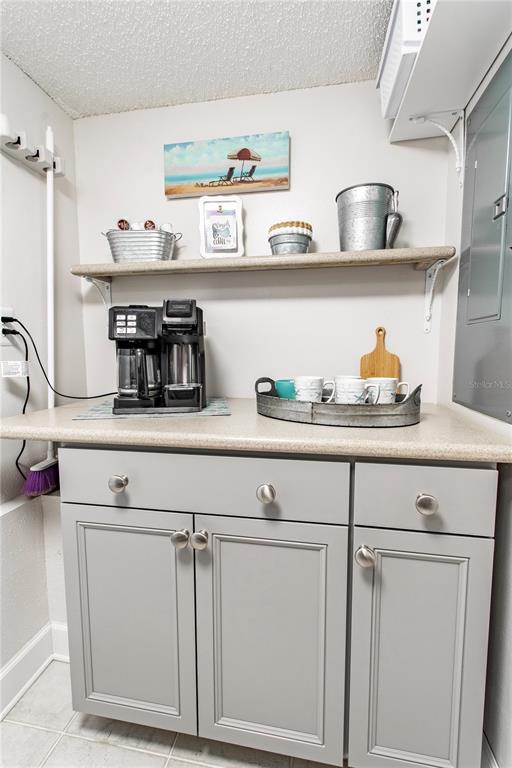 15316 Gulf Boulevard, Unit 402 Madeira Beach, FL 33708 - Photo 14 of 41 a kitchen with white cabinets and wooden floor