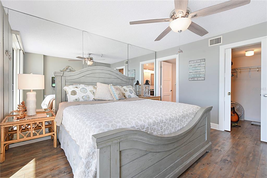 15316 Gulf Boulevard, Unit 402 Madeira Beach, FL 33708 - Photo 16 of 41 a bedroom with a bed and wooden floor