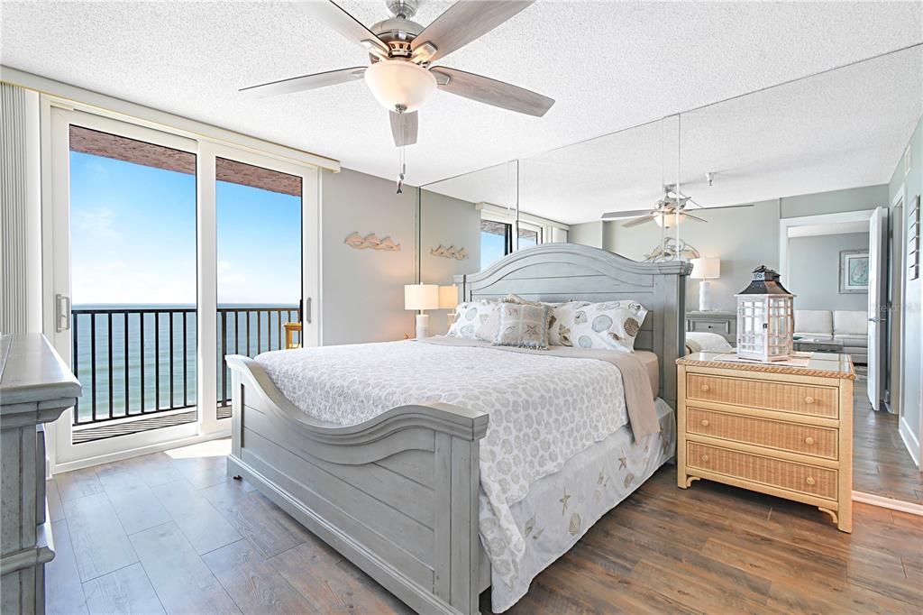 15316 Gulf Boulevard, Unit 402 Madeira Beach, FL 33708 - Photo 18 of 41 a bedroom with a bed and a chandelier