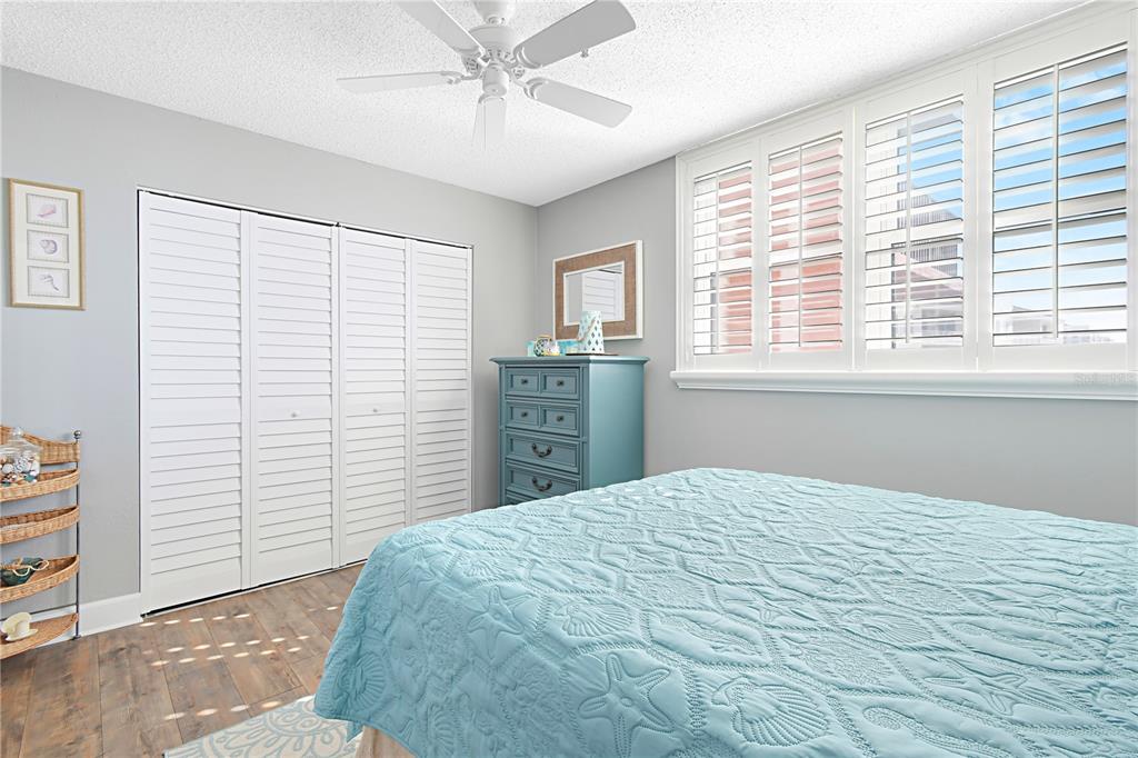 15316 Gulf Boulevard, Unit 402 Madeira Beach, FL 33708 - Photo 22 of 41 a bedroom with a large bed and a window