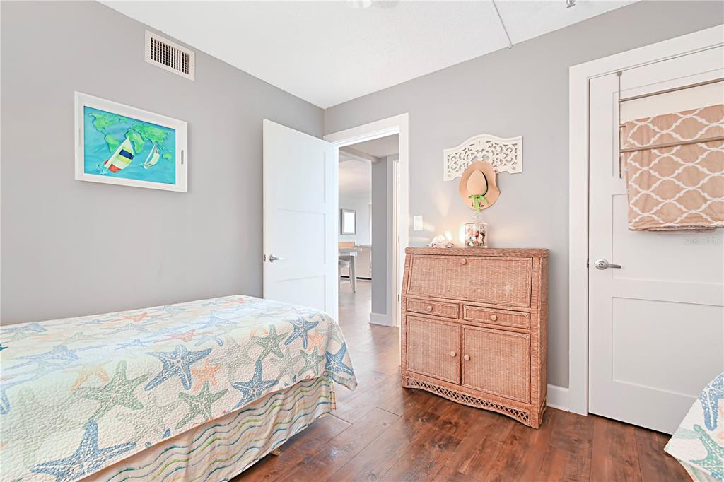 15316 Gulf Boulevard, Unit 402 Madeira Beach, FL 33708 - Photo 25 of 41 a bedroom with a bed and a table in it