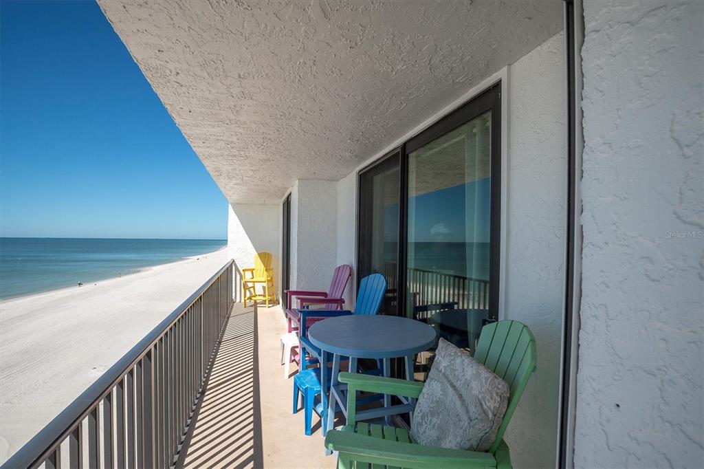 15316 Gulf Boulevard, Unit 402 Madeira Beach, FL 33708 - Photo 33 of 41 a balcony with furniture and a potted plant