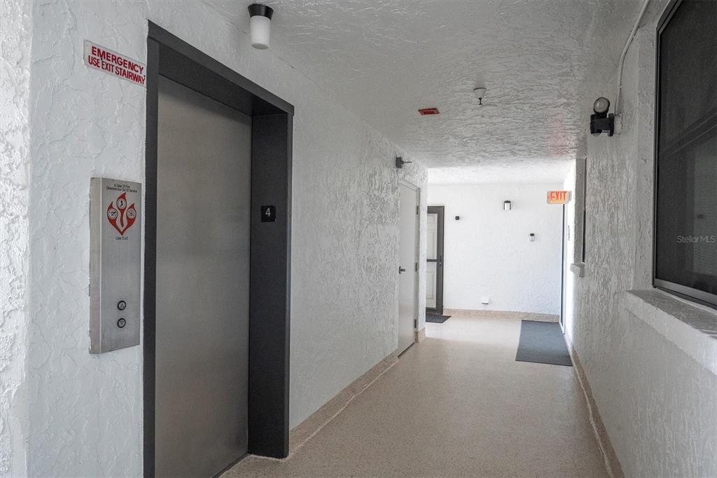 15316 Gulf Boulevard, Unit 402 Madeira Beach, FL 33708 - Photo 40 of 41 a view of a hallway with wooden shelves