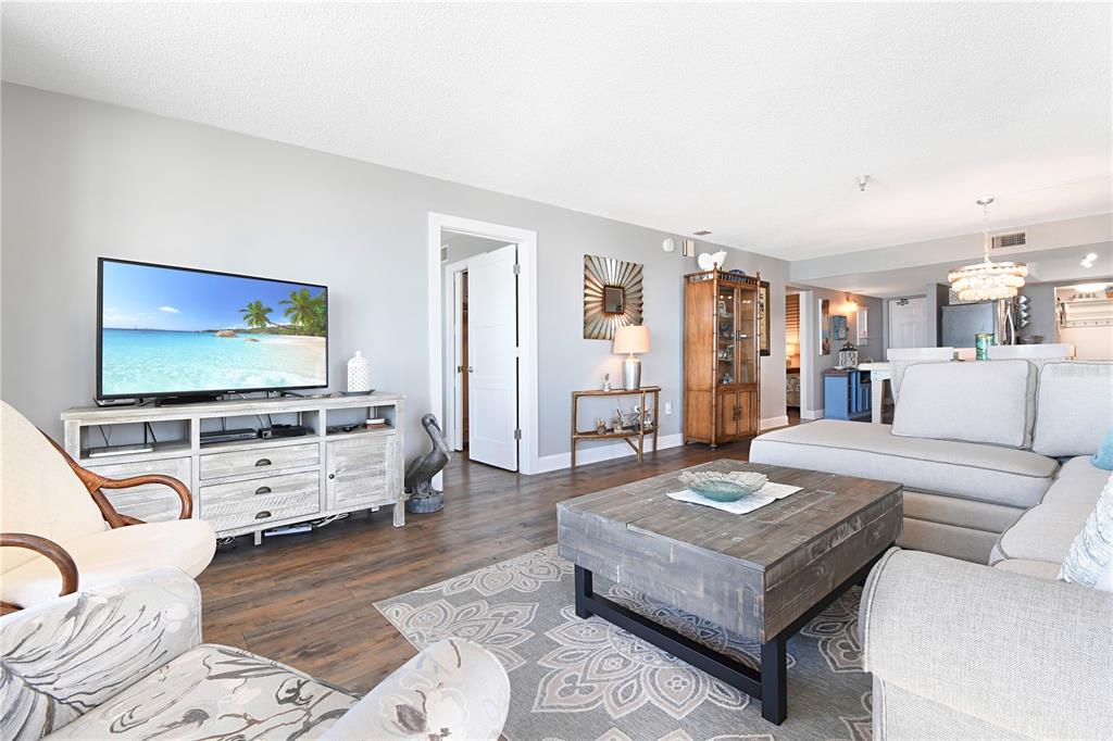 15316 Gulf Boulevard, Unit 402 Madeira Beach, FL 33708 - Photo 5 of 41 a living room with furniture and a flat screen tv