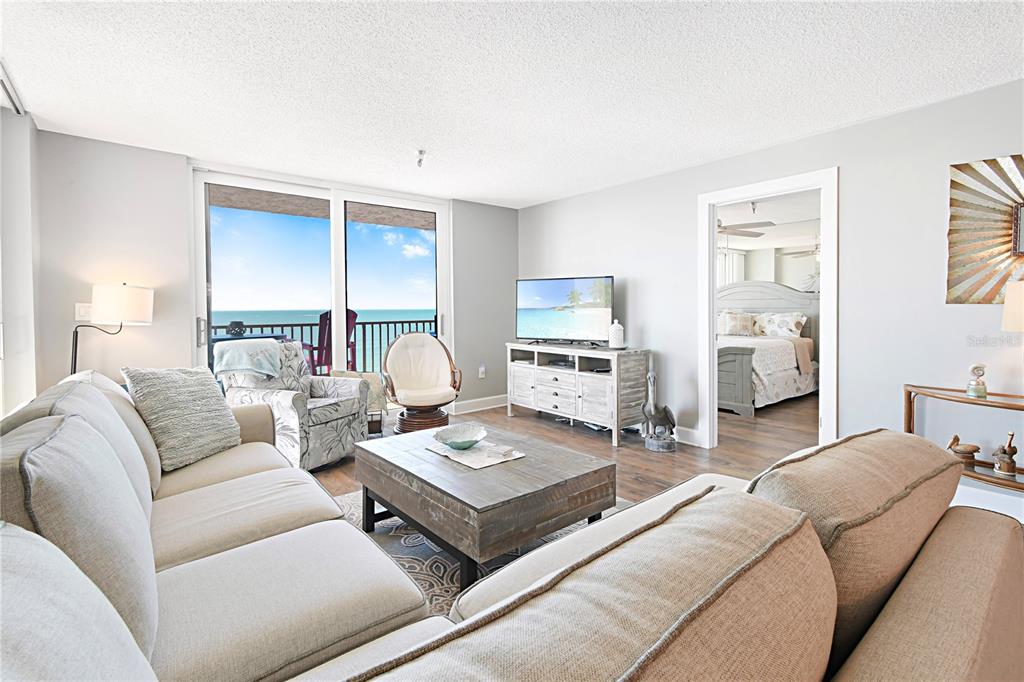 15316 Gulf Boulevard, Unit 402 Madeira Beach, FL 33708 - Photo 7 of 41 a living room with furniture and a wooden floor