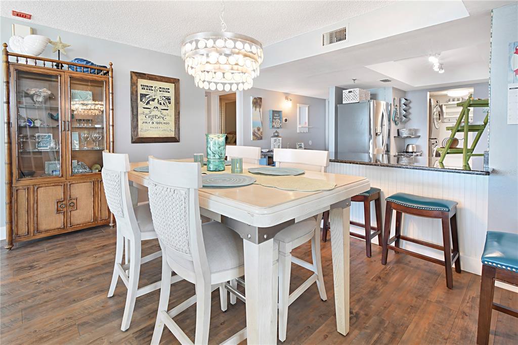 15316 Gulf Boulevard, Unit 402 Madeira Beach, FL 33708 - Photo 8 of 41 a view of a dining room with furniture window and wooden floor