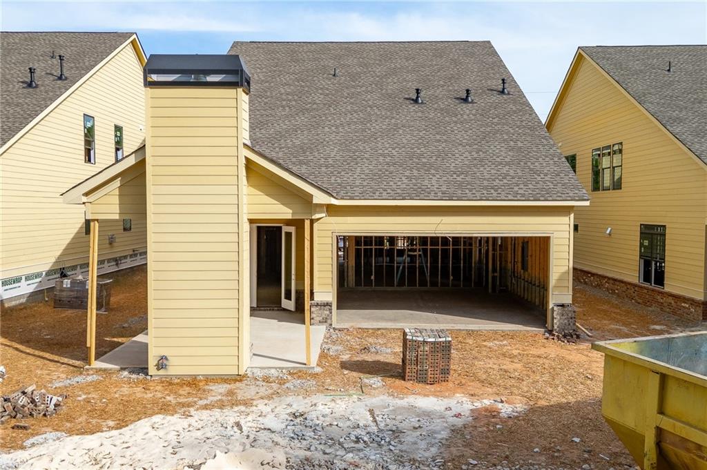 5812 Mitchell Street Flowery Branch, GA 30542 - Photo 3 of 8 a view of a house with wooden fence and a floor to ceiling window