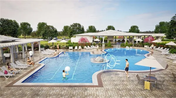 swimming pool view with a seating space