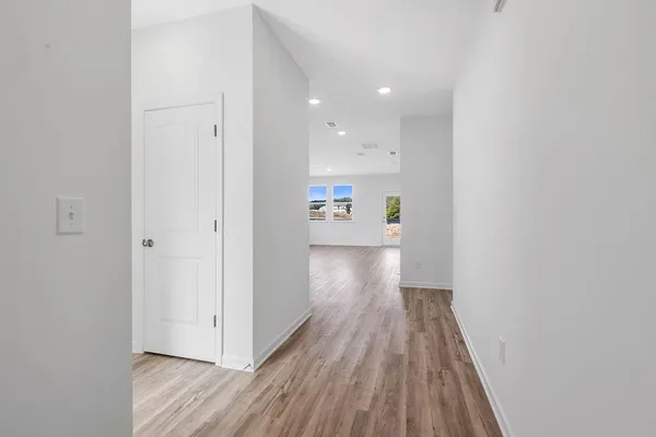 a view of a hallway with wooden floor