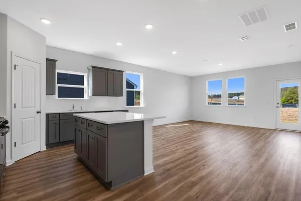 a kitchen with stainless steel appliances granite countertop a stove and a sink