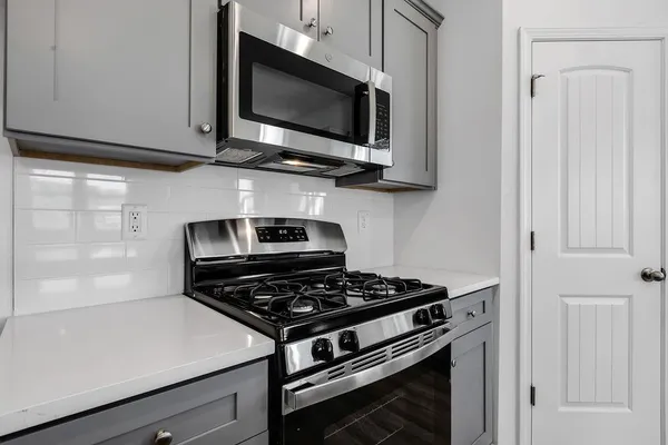 a kitchen with a stove and a microwave