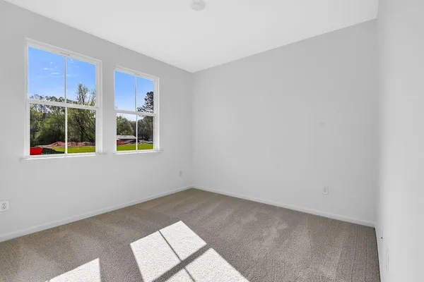 a view of an empty room with windows