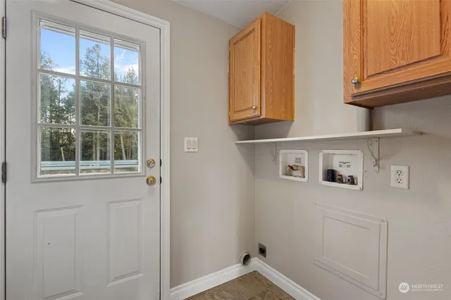 a view of a refrigerator in kitchen and window