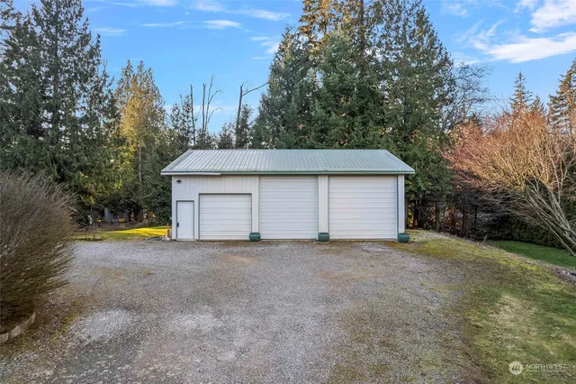 a view of a house with a yard and garage