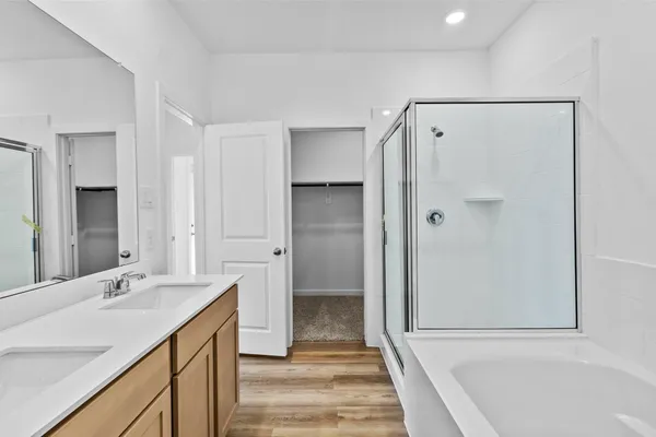 a bathroom with a shower sink and mirror