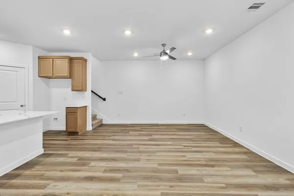 a view of a room with a sink and a mirror