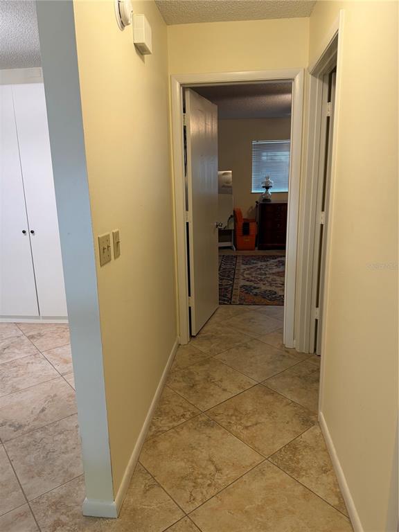 9529 Southwest 85th Avenue, Unit D Ocala, FL 34481 - Photo 18 of 21 a view of a hallway with wooden shelves