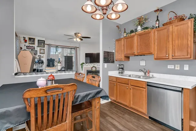 a kitchen with stainless steel appliances granite countertop a sink dishwasher stove and cabinets