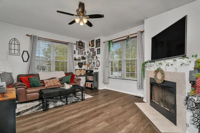 a living room with furniture a flat screen tv and a fireplace
