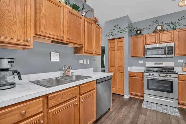 a kitchen with stainless steel appliances granite countertop a sink stove and refrigerator