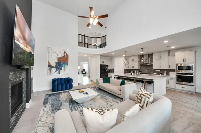 a living room with fireplace furniture and a flat screen tv