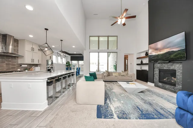 a living room with fireplace furniture and a large window