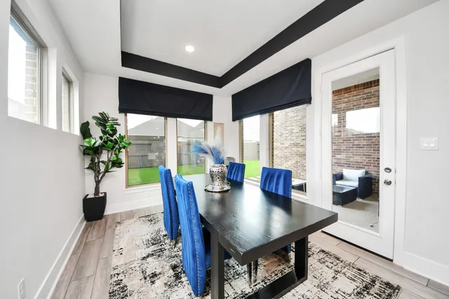 a large kitchen with dining table and chairs
