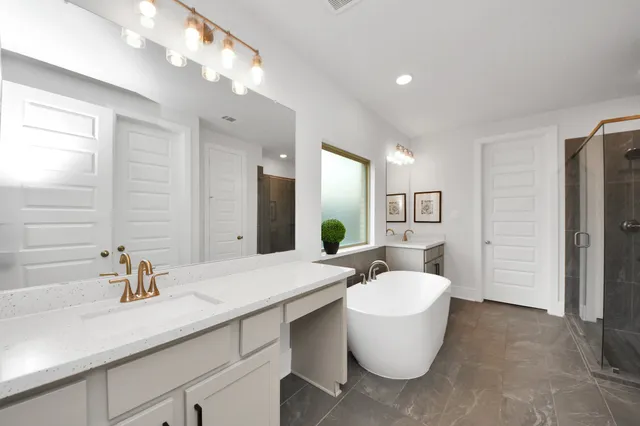 a bathroom with a tub sink and mirror