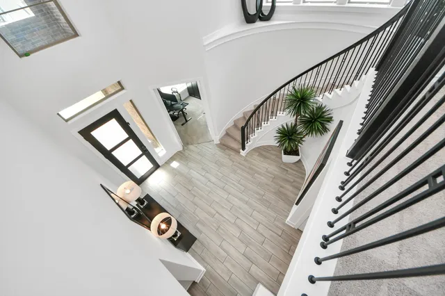 a bedroom with a bed and a potted plant