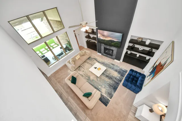 a kitchen with stainless steel appliances kitchen island granite countertop a stove top oven a sink dishwasher a dining table and chairs with wooden floor