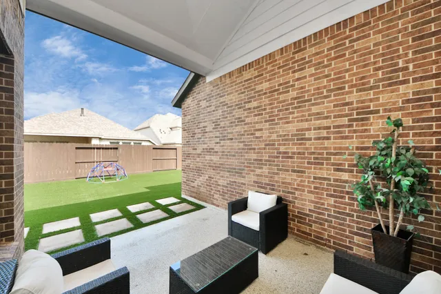 a view of a house with a yard and sitting area