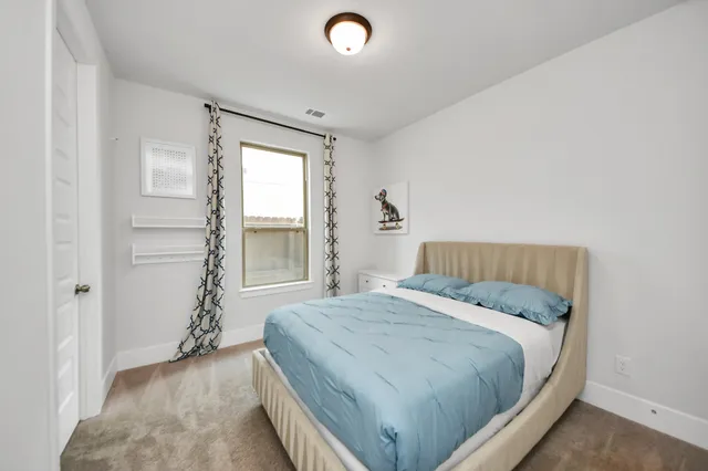 a bedroom with a bed and a cabinets