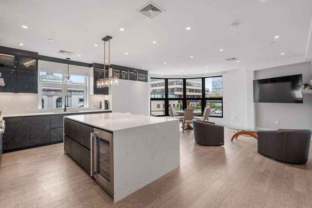 a kitchen with a stove a refrigerator and a television
