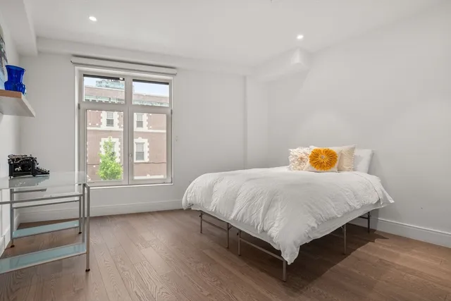 a bed sitting in a bedroom next to a window