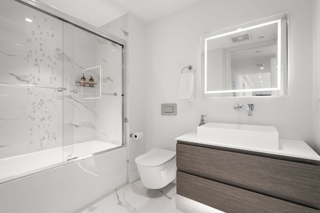 69 Walnut Street, Unit 4/5 Brookline, MA 02445 - Photo 15 of 26 a bathroom with a sink a toilet and shower