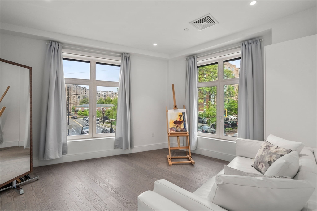 69 Walnut Street, Unit 4/5 Brookline, MA 02445 - Photo 17 of 26 a living room with furniture and a large window