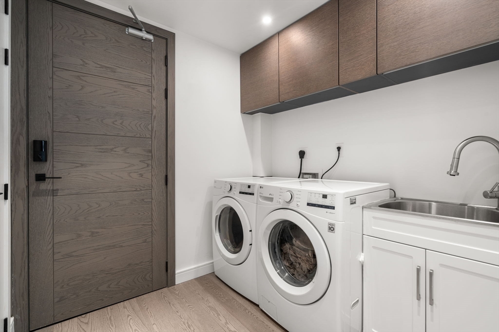 69 Walnut Street, Unit 4/5 Brookline, MA 02445 - Photo 18 of 26 a utility room with dryer and washer