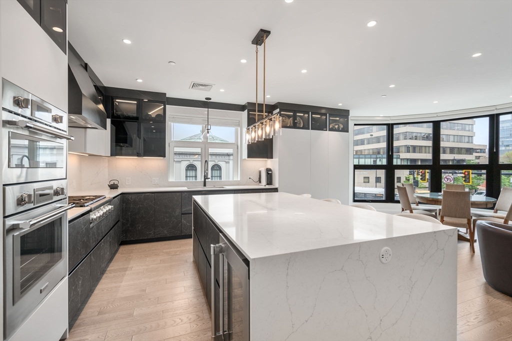 69 Walnut Street, Unit 4/5 Brookline, MA 02445 - Photo 2 of 26 a large kitchen with stainless steel appliances granite countertop a sink and a stove