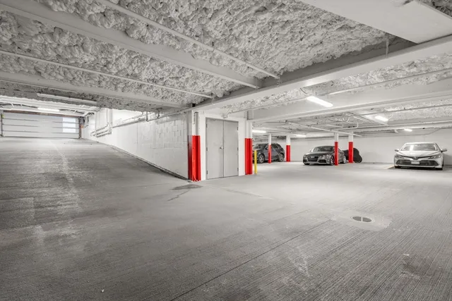 a view of garage with cars
