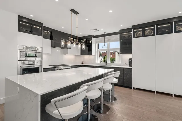 a kitchen with a table chairs refrigerator and microwave