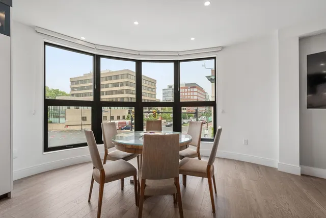a view of a dining room with furniture and a window